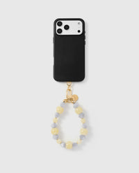 Full phone with butter frost cluster strap attached on light background