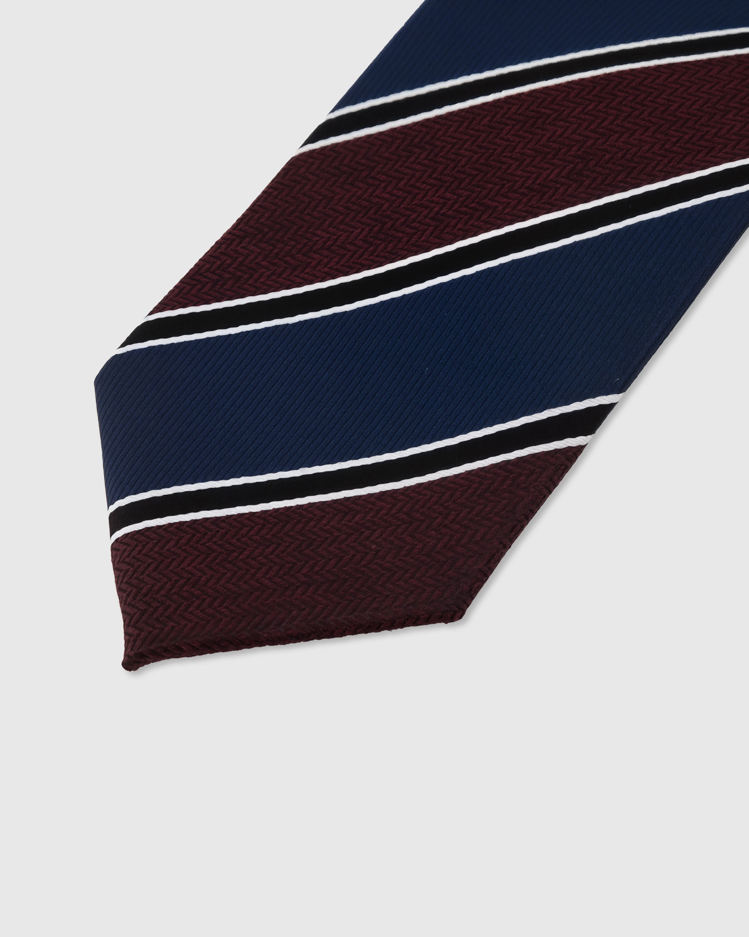 Regiment stripe detail on claret and steel blue mulberry silk tie showing raised hand-embroidered thread by STICKYZOO