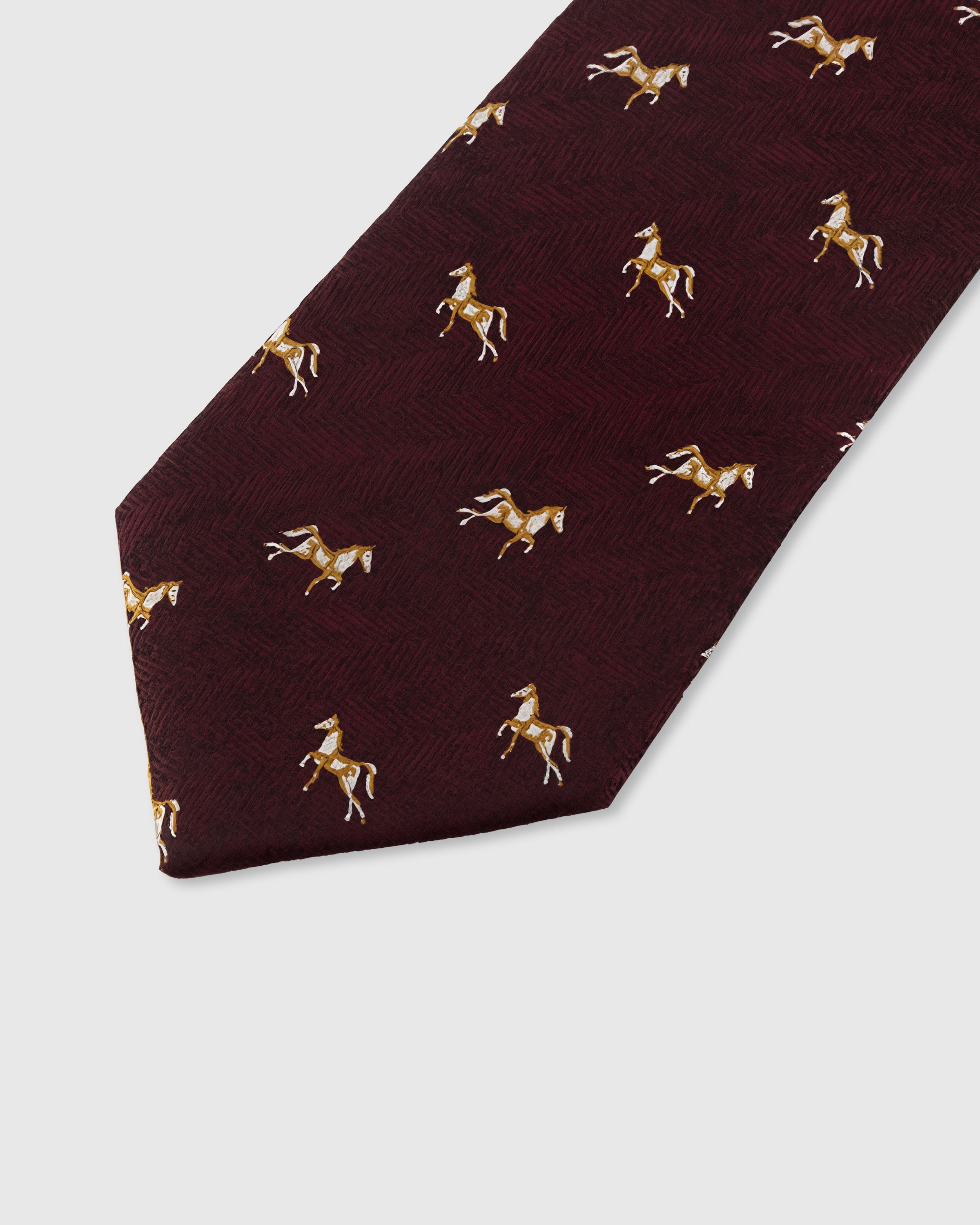 STICKYZOO MERLOT EQUESTRIAN TIE — hand-embroidered detail showing gold embroidered galloping horse motifs, stitched not printed