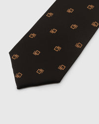 Gold geometric crest motif on espresso basket-weave silk tie showing hand-embroidered detail by STICKYZOO