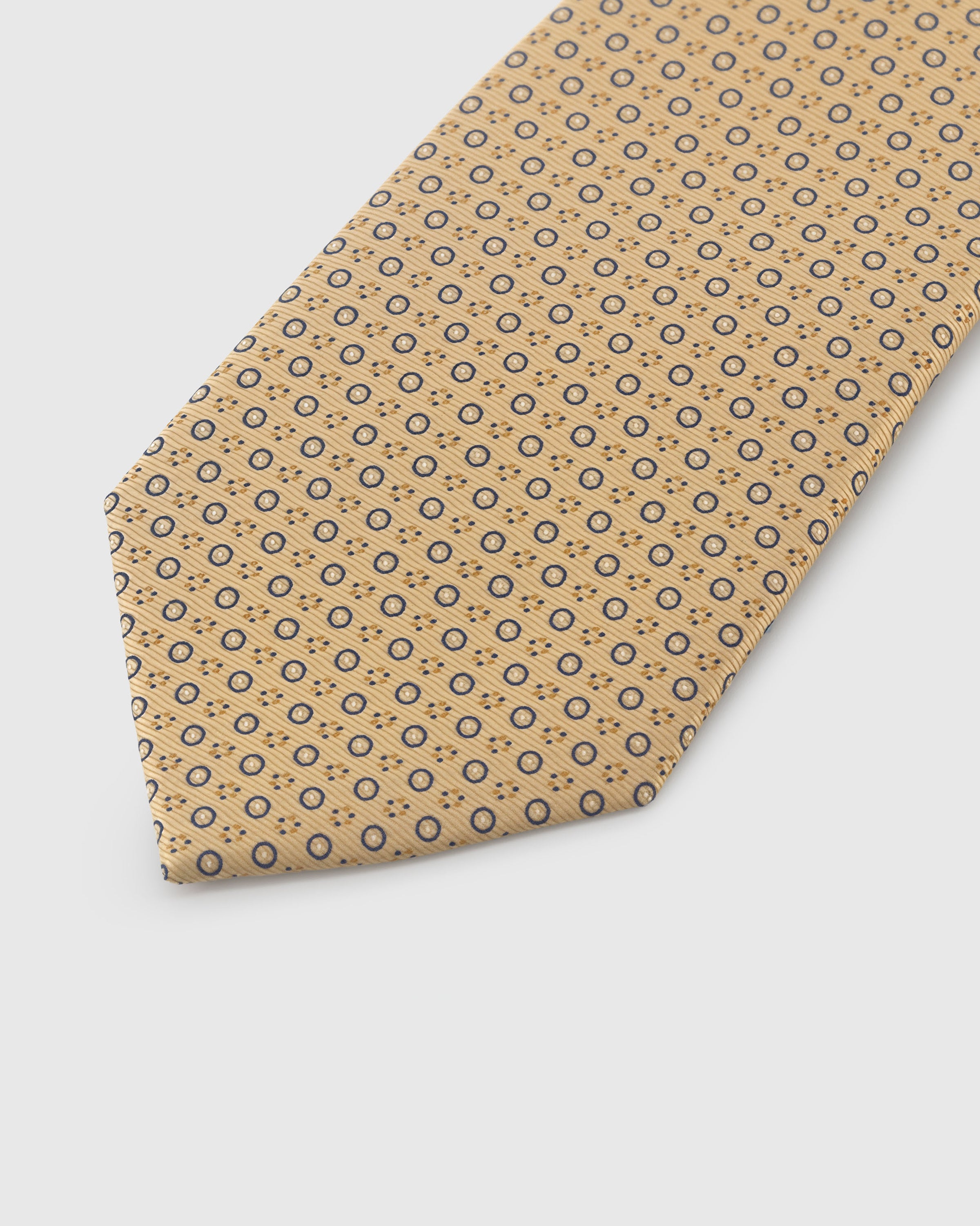 Navy circlet motif detail on honeycomb mulberry silk tie showing raised embroidered rings by STICKYZOO