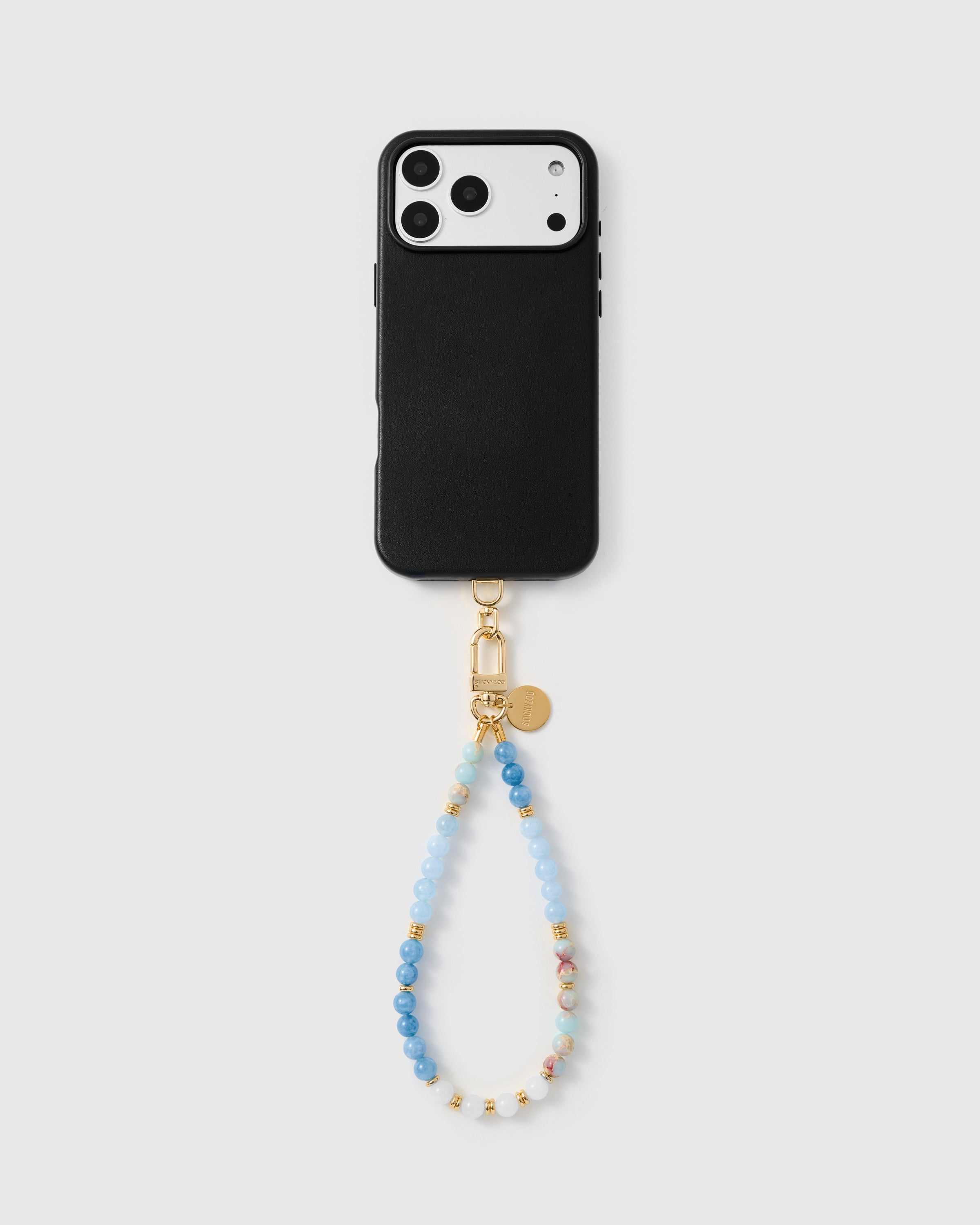 Close-up of natural blue agate and pink marble stone beads with gold spacer details