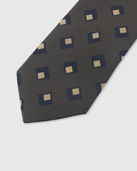 STICKYZOO GRAPHITE DIAMOND TIE — hand-embroidered detail showing navy and gold nested diamond motifs, stitched not printed