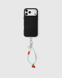 Full phone with cherry beaded strap attached on grey background