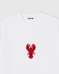 Hand-beaded lobster on the white Lobster T-Shirt showing red glass beads and layered sequins on 230gsm cool-touch cotton.