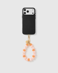 Handmade beaded phone strap on a black case, rated 4.9 across 5,000+ reviews