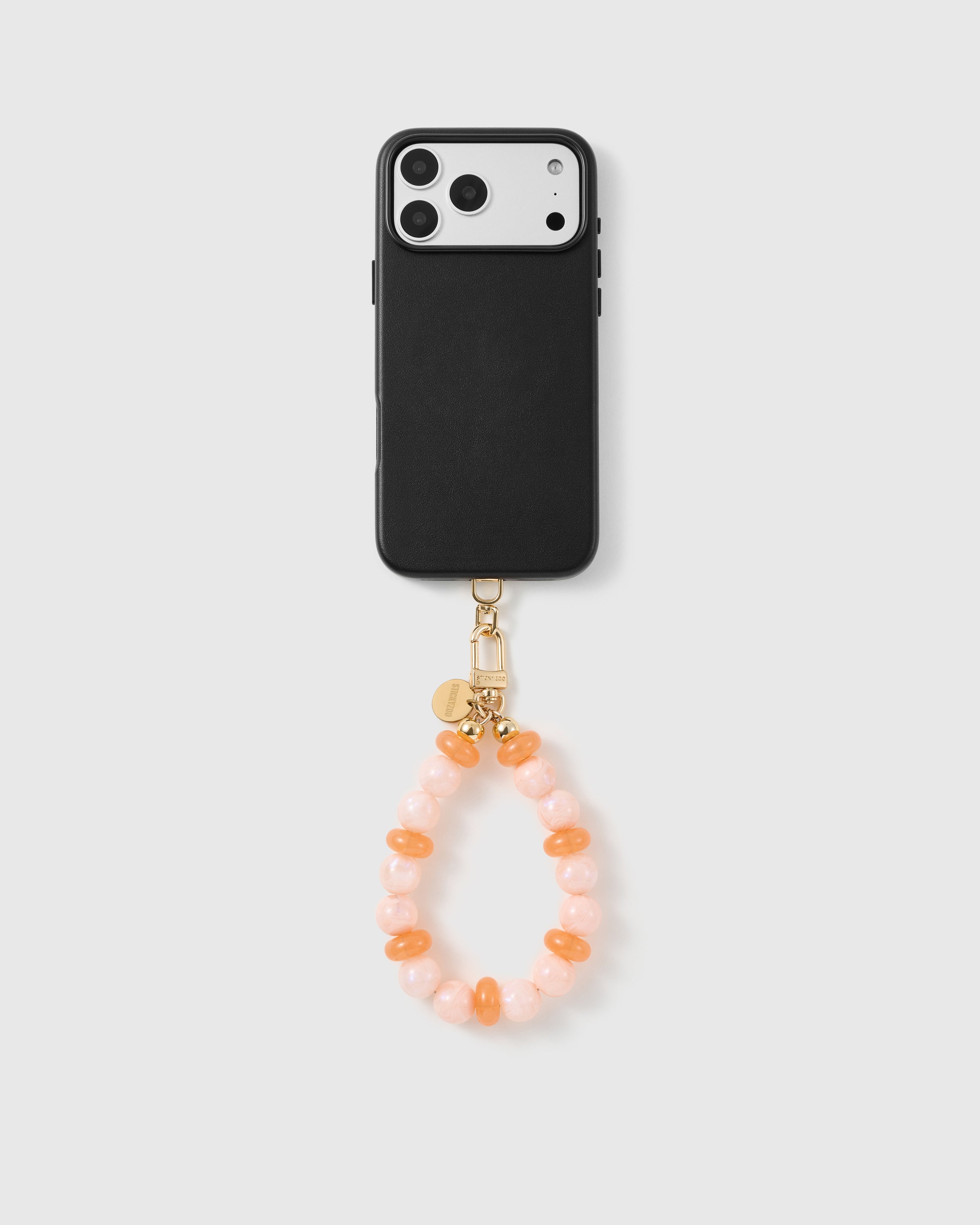 Handmade beaded phone strap on a black case, rated 4.9 across 5,000+ reviews