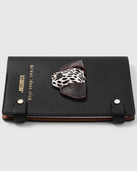 Dalmatian face charm detail showing black and white spotted leather with brown ears on STICKYZOO A5 notebook