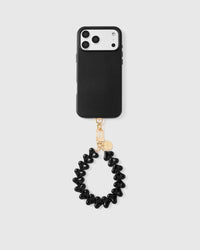 Full phone with noir heart strap attached on light grey background