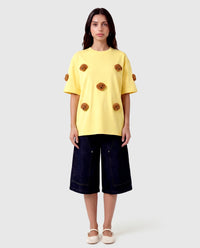 Model in lemon Poodle Parade T-Shirt front view showing all seven plush poodle appliques
