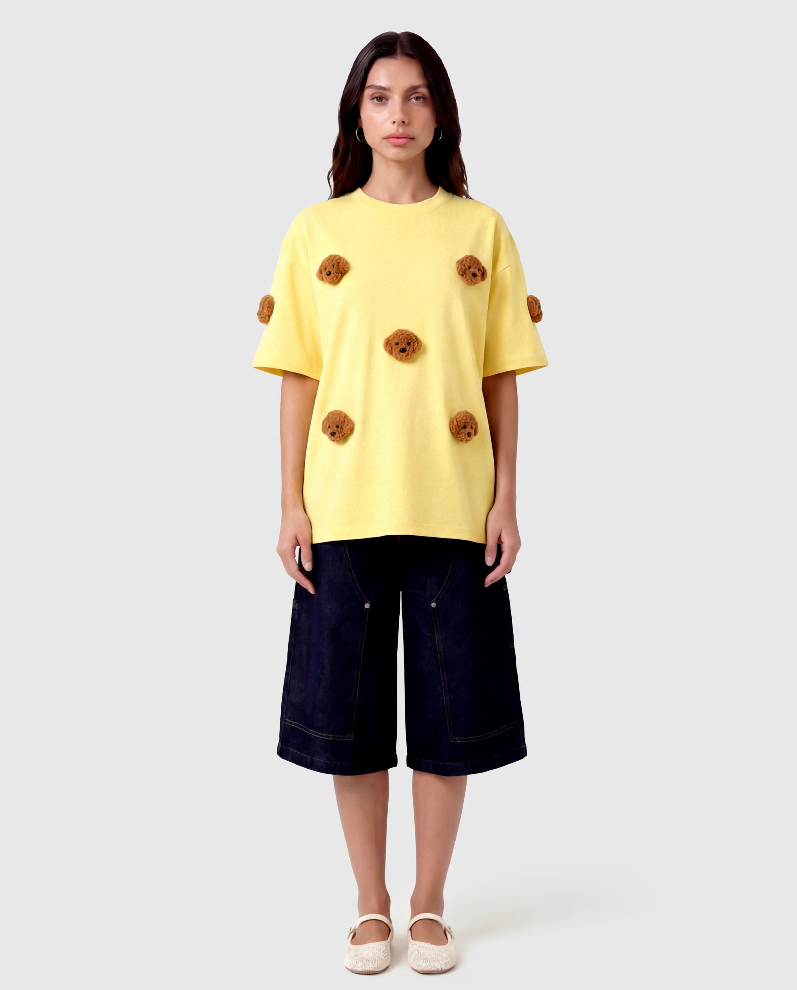 Model in lemon Poodle Parade T-Shirt front view showing all seven plush poodle appliques