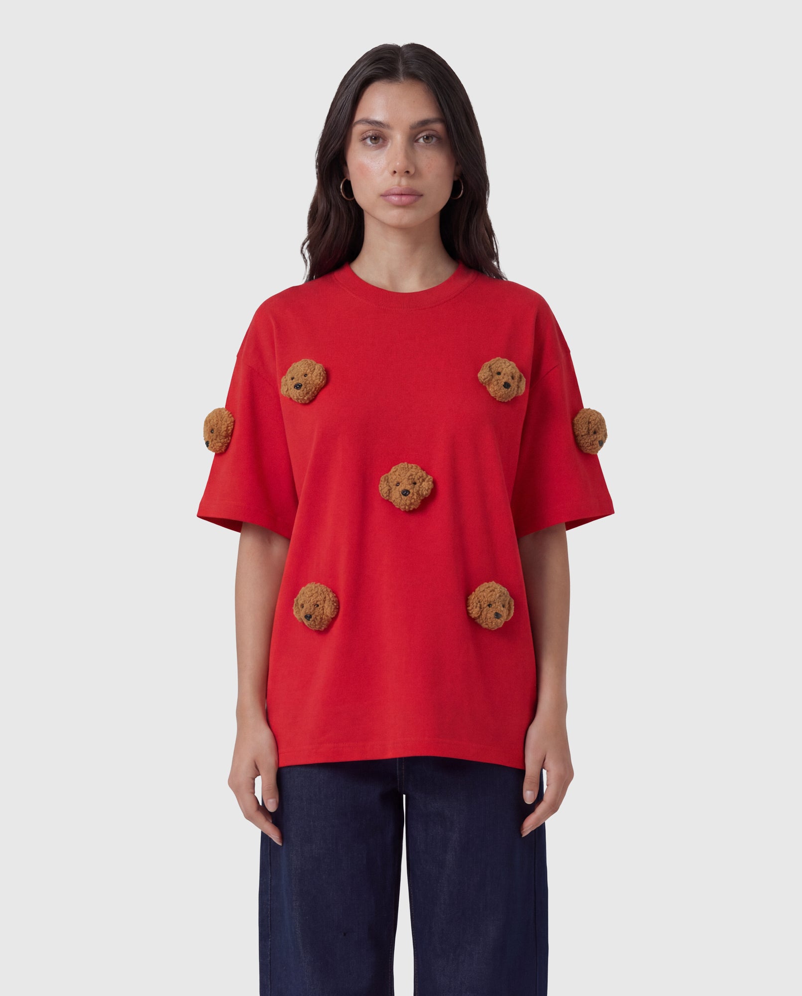 Model in red Poodle Parade T-Shirt front view showing all seven plush poodle appliques