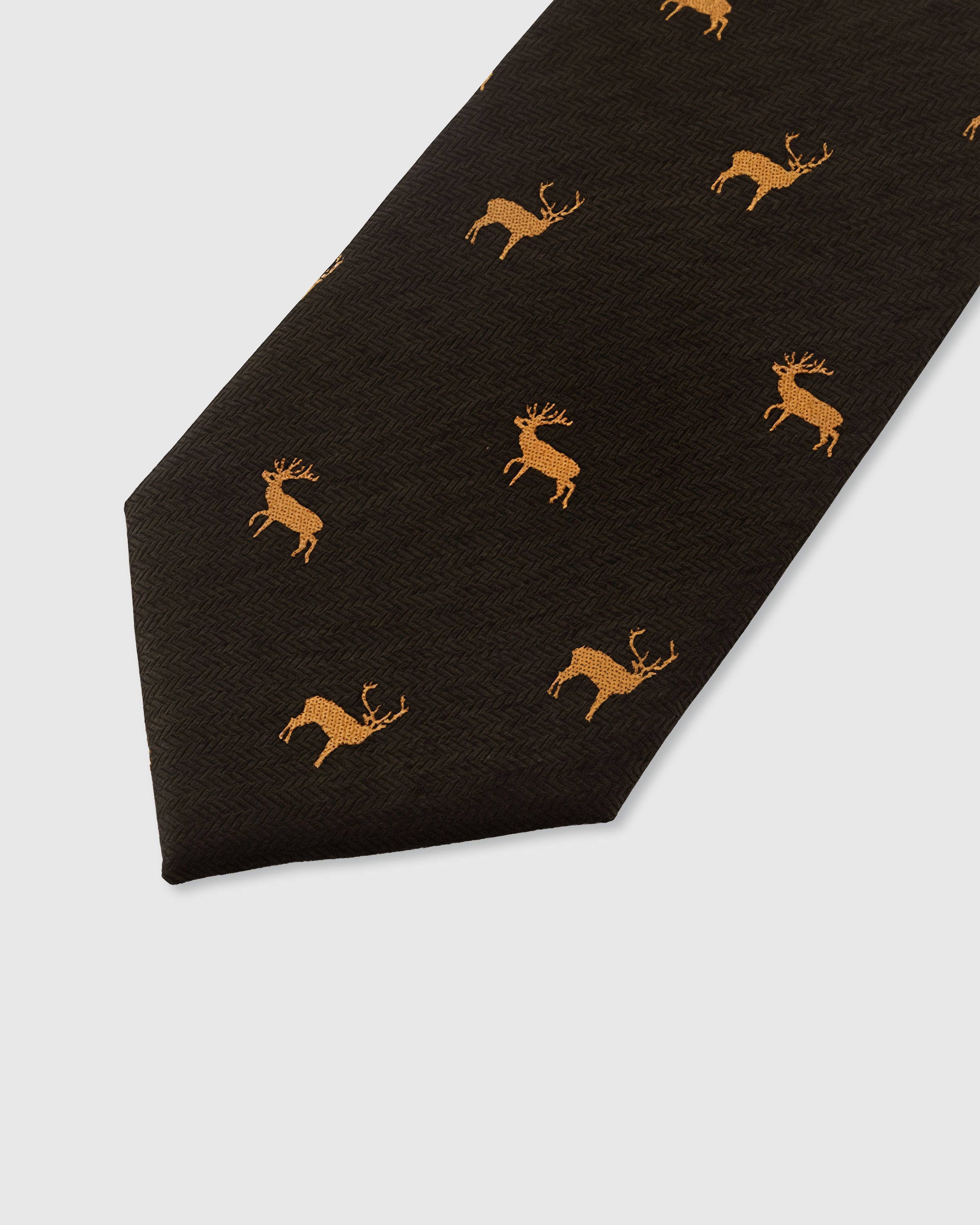 STICKYZOO ESPRESSO STAG TIE — hand-embroidered detail showing golden embroidered stag silhouettes, stitched not printed