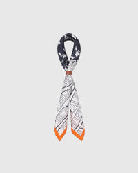STICKYZOO tangerine frame silk scarf looped through a leather cuff showing the orange border