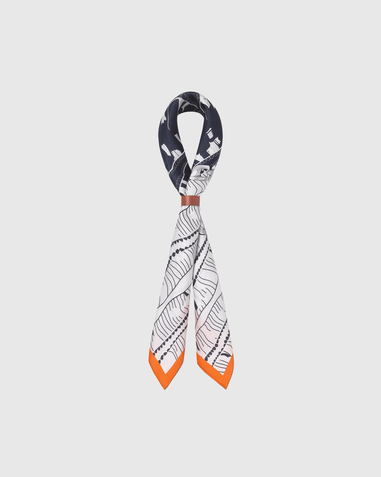 STICKYZOO tangerine frame silk scarf looped through a leather cuff showing the orange border