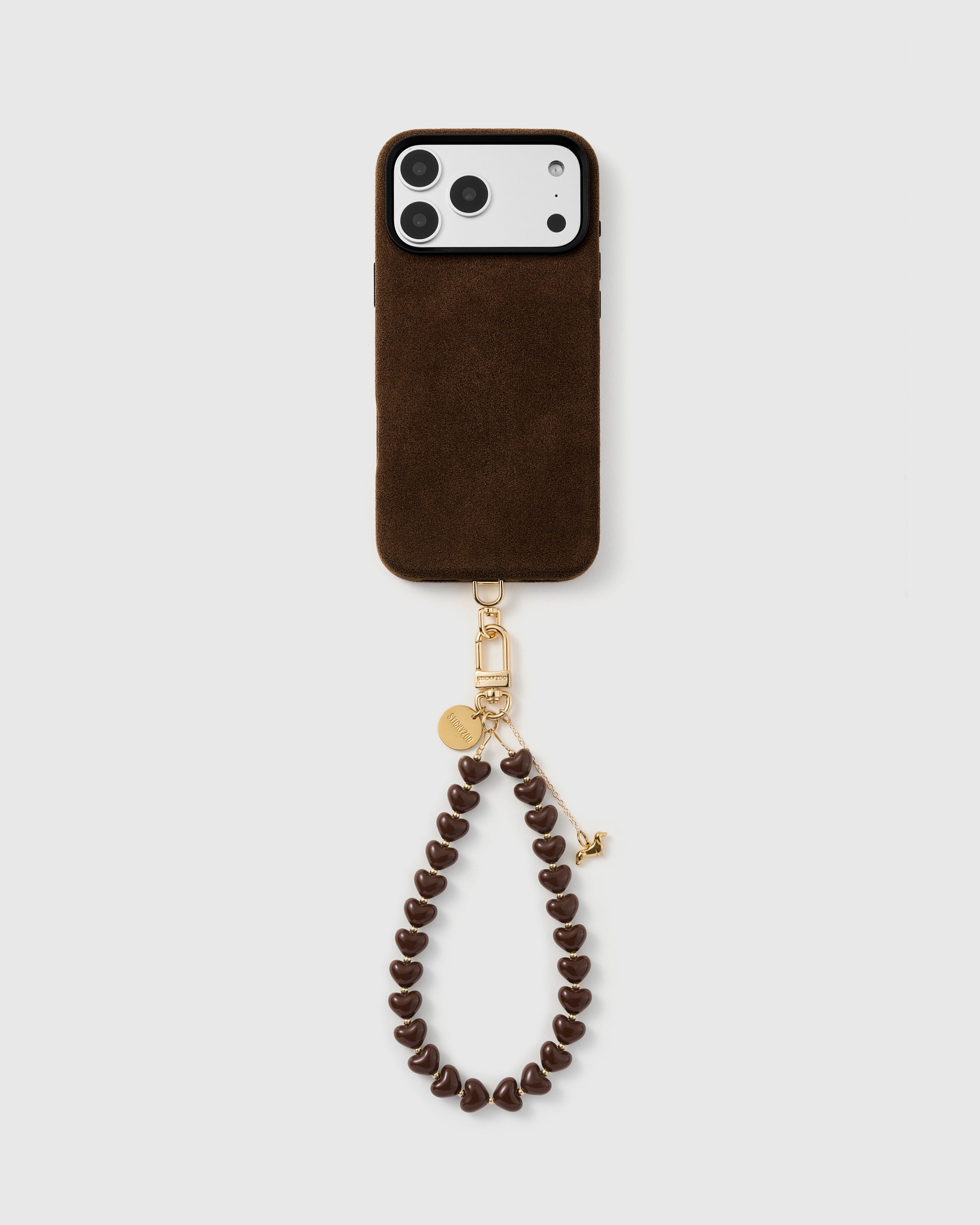 Full phone with the cocoa dachshund heart strap clipped on, hanging from the base of a black phone case.