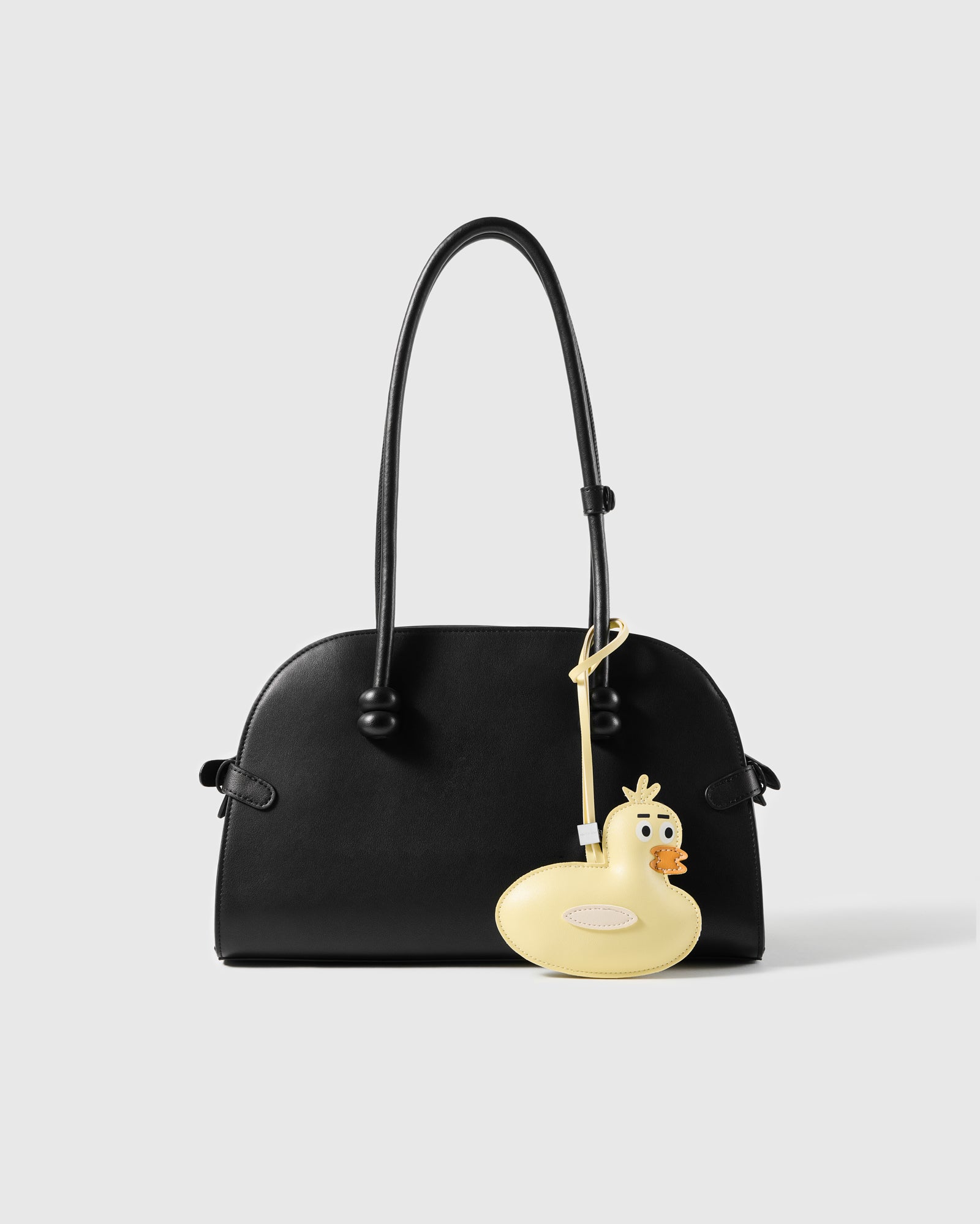 STICKYZOO leather duck charm shown on a handbag strap, genuine French goatskin, handmade by hand