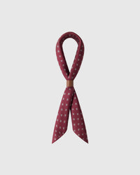 STICKYZOO foulard carré silk scarf looped through a leather cuff showing the neat micro-print