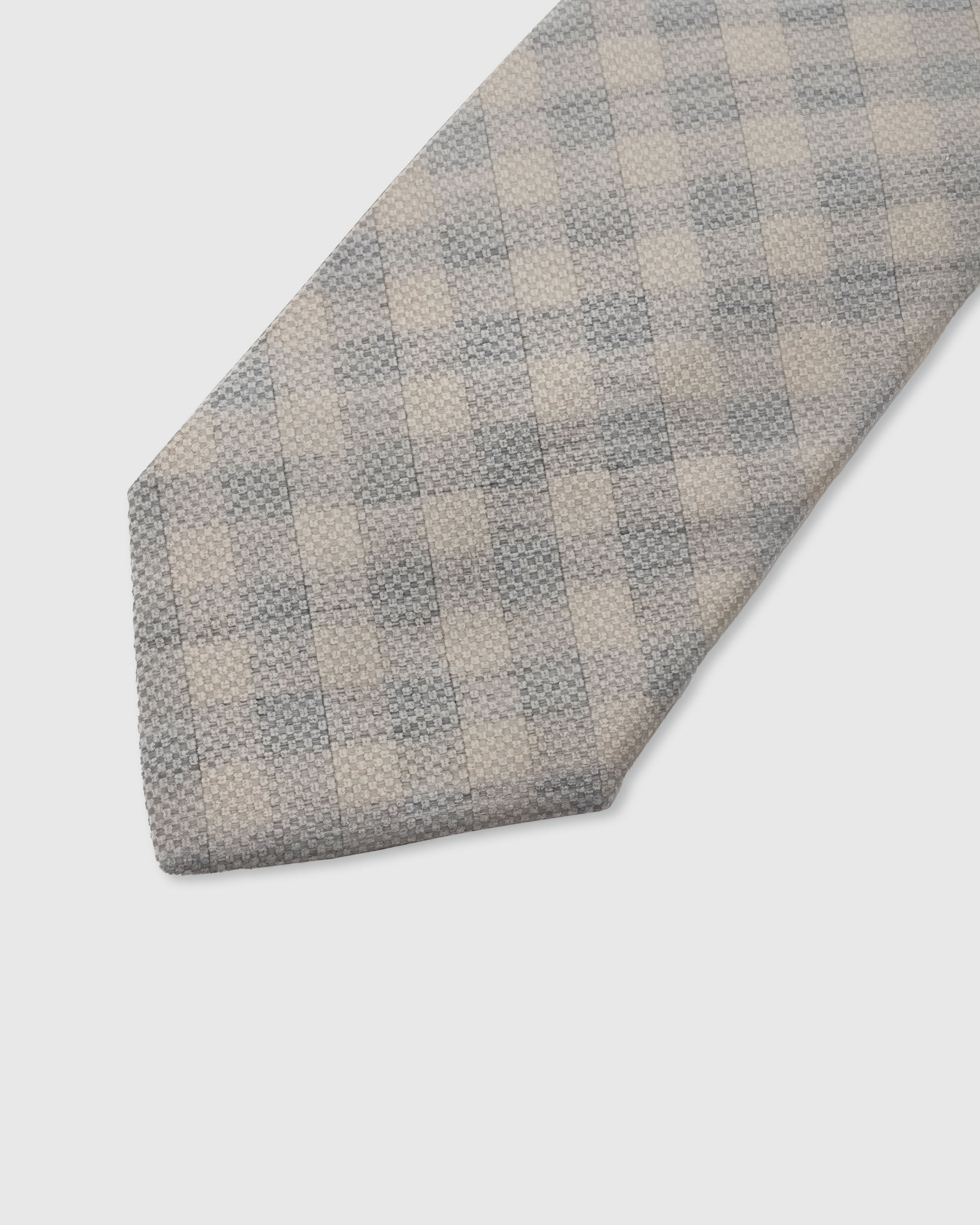 SILVER HOUNDSTOOTH TIE — 45° Italian bias-cut construction with structured interlining, hand-finished slip stitching visible on interior