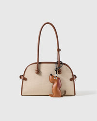STICKYZOO leather puppy charm shown on a handbag handle, clips onto any bag or keychain