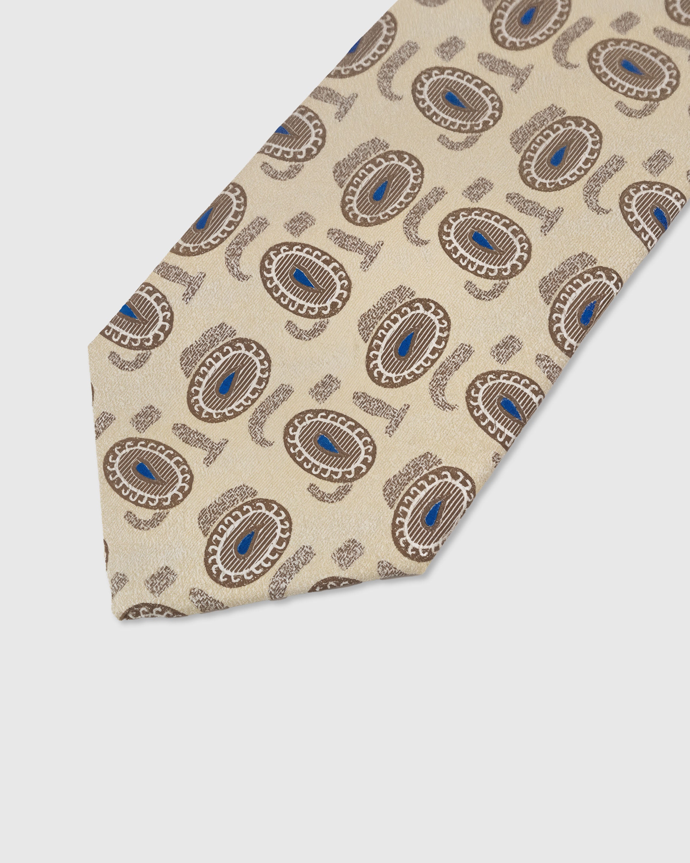 Azure paisley medallion detail on sandstone mulberry silk tie showing raised hand-embroidered thread by STICKYZOO