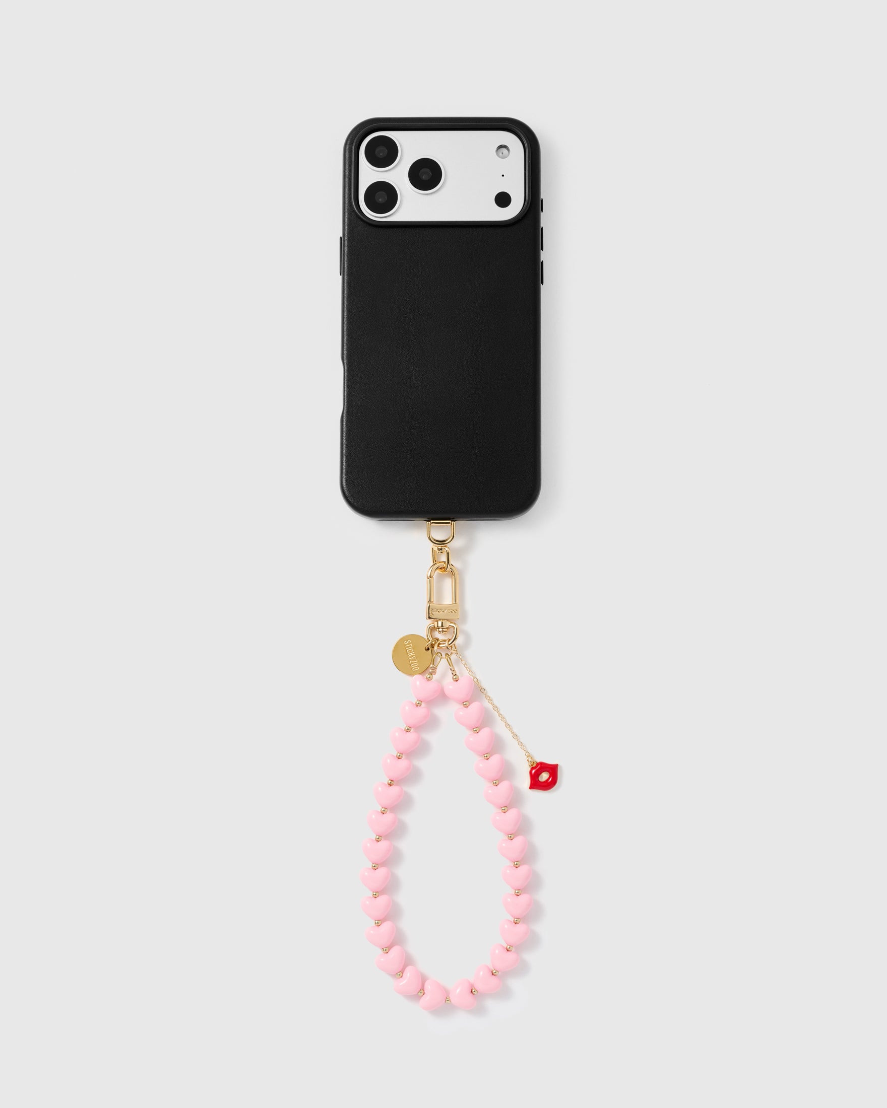 Pink heart phone strap worn as a wrist loop showing hands-free everyday phone carry