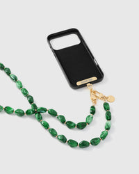 Full phone with emerald smoke strap draped alongside on neutral background