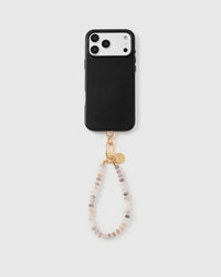 Full phone with blush agate orbit strap attached on light grey background