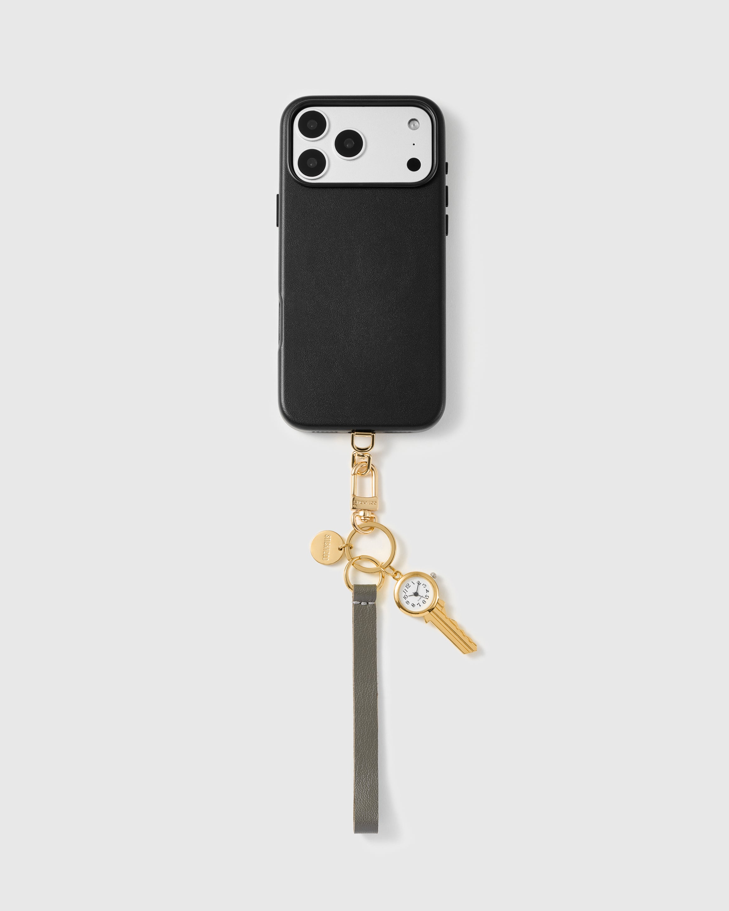 Close-up of pebbled storm grey French Alran leather edge with engraved gold STICKYZOO hardware