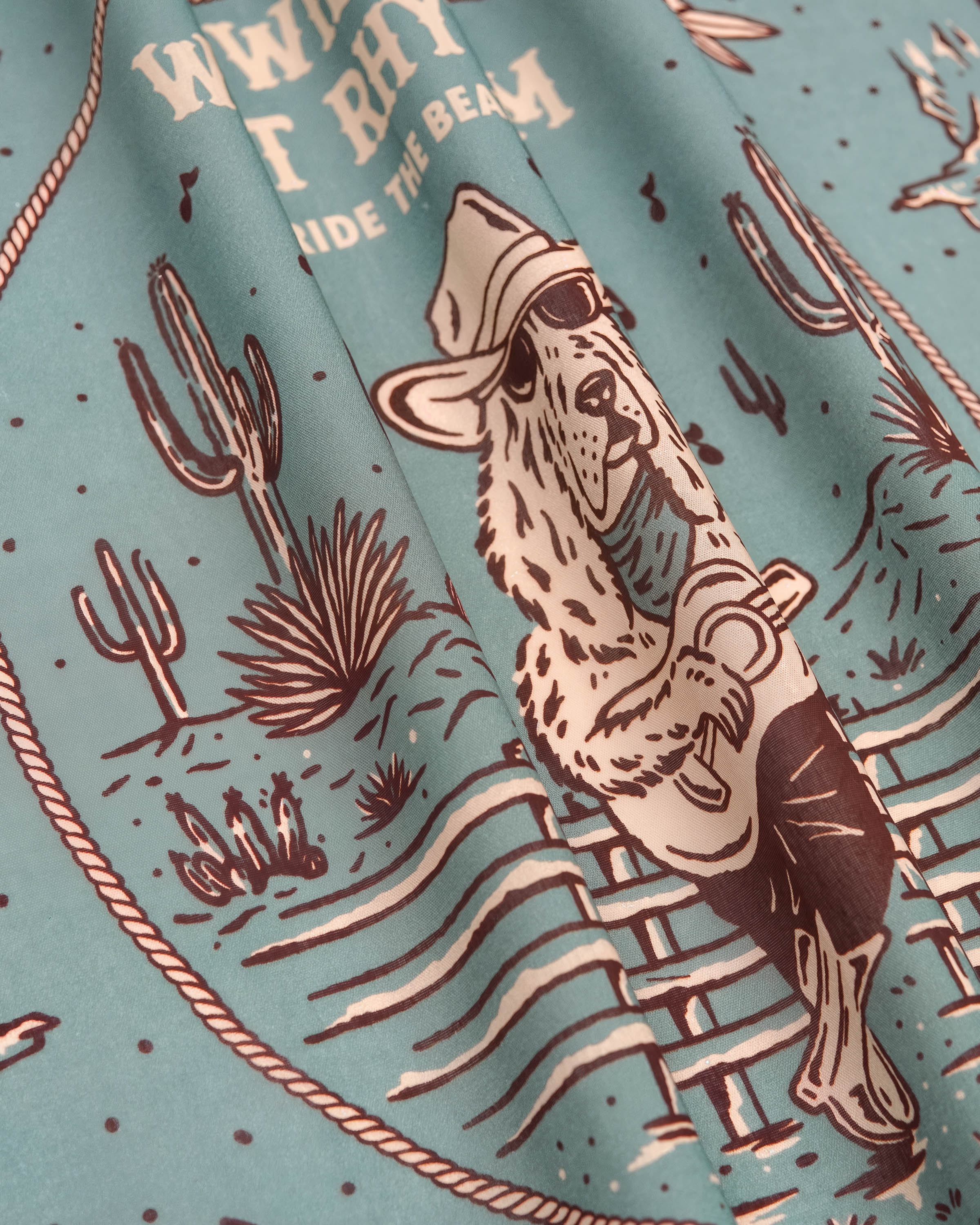 STICKYZOO sage west rhythm silk scarf print detail showing the cowboy dog with guitar and cacti
```