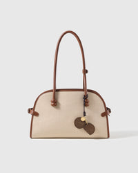 STICKYZOO leather cookie charm shown on a canvas handbag, French goatskin, handmade over three days