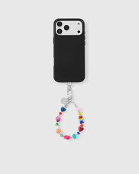 Full phone with rainbow heart wrist strap attached on light grey background
