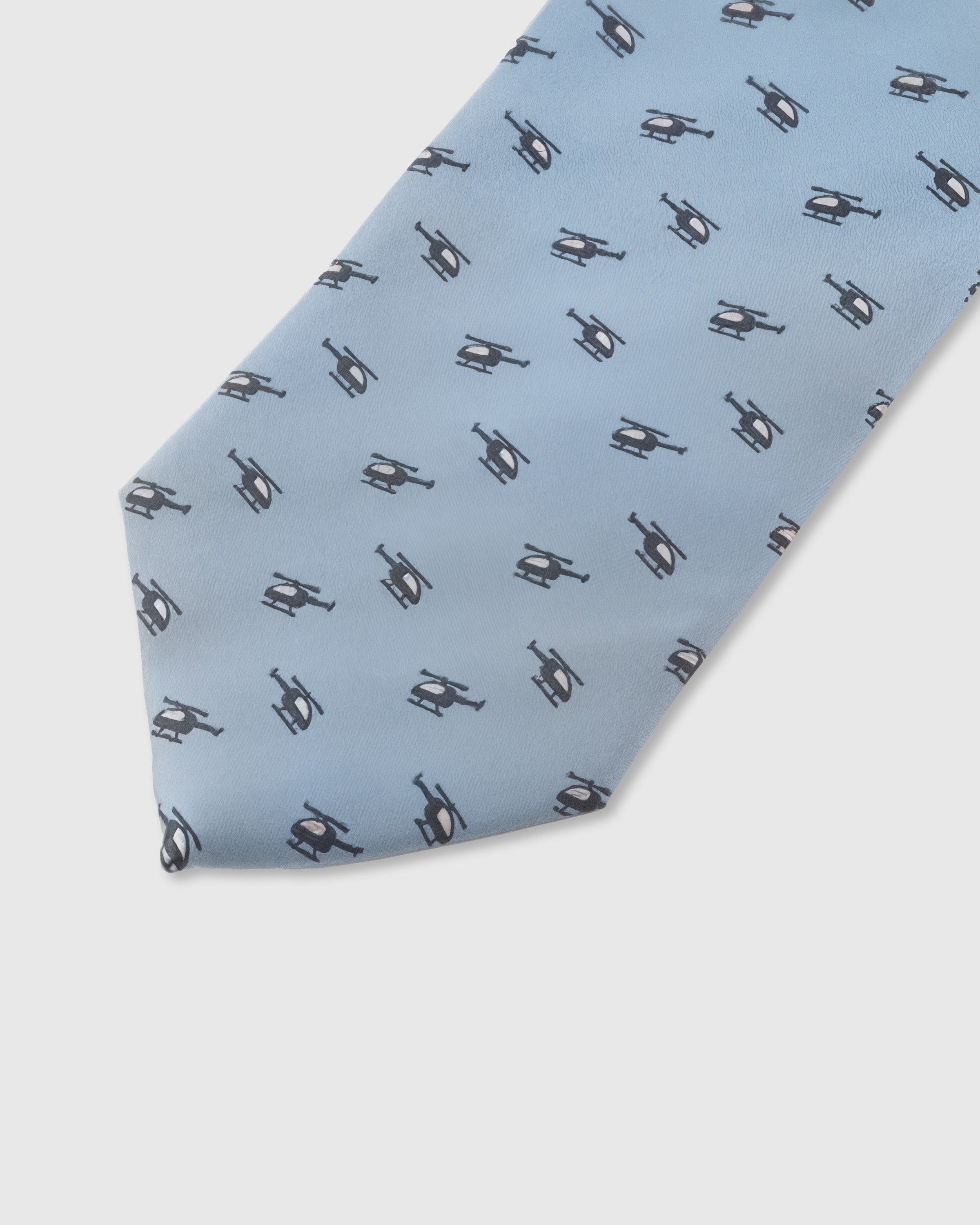Slate helicopter motif detail on sky blue mulberry silk tie showing raised hand-embroidered silhouette by STICKYZOO