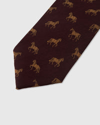 Amber stallion motif detail on garnet mulberry silk tie showing raised hand-embroidered thread by STICKYZOO