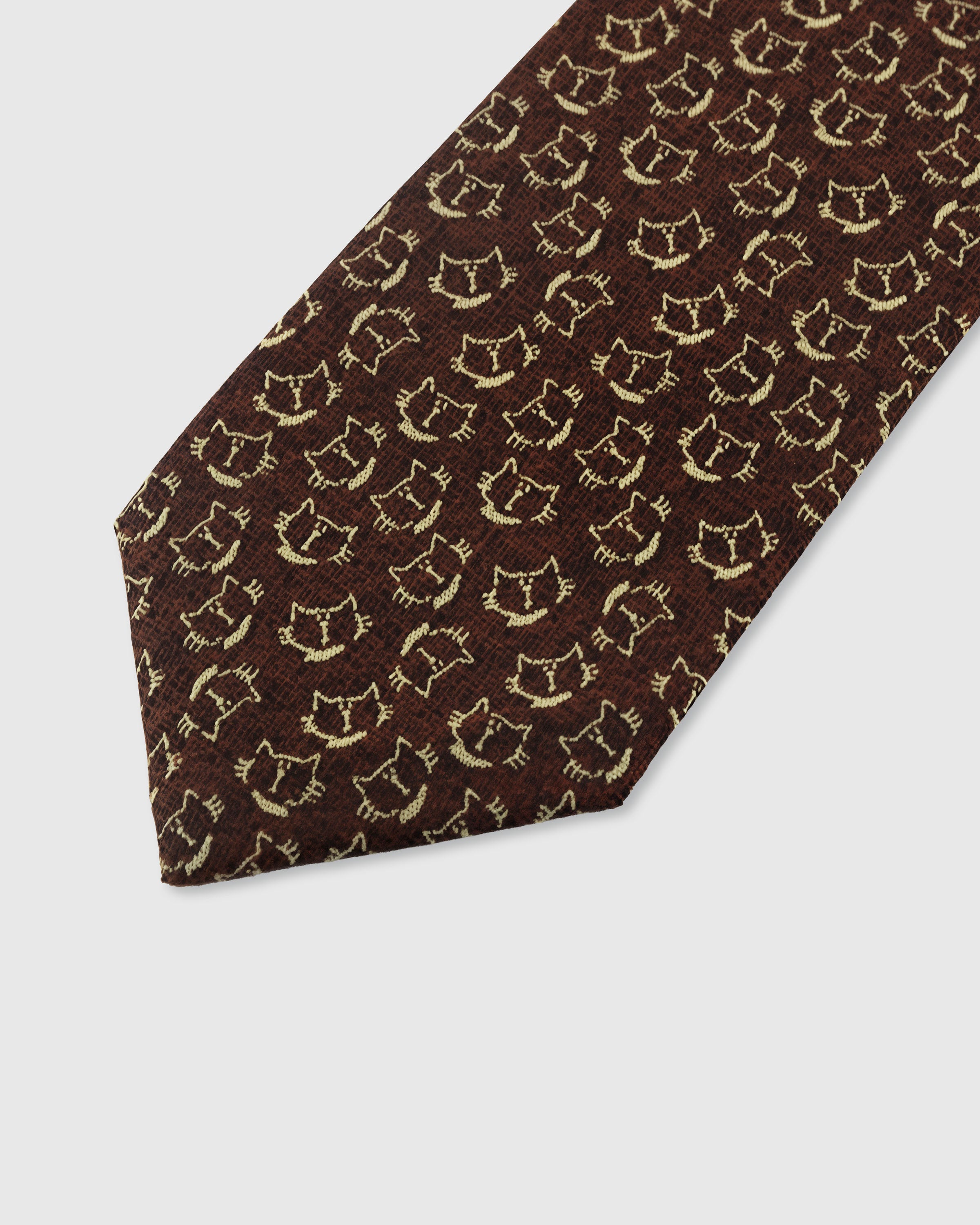STICKYZOO COCOA CAT TIE — hand-embroidered detail showing gold-toned smiling cat face motifs, stitched not printed
