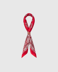 STICKYZOO crimson bandana silk scarf looped through a leather slide showing the paisley border
