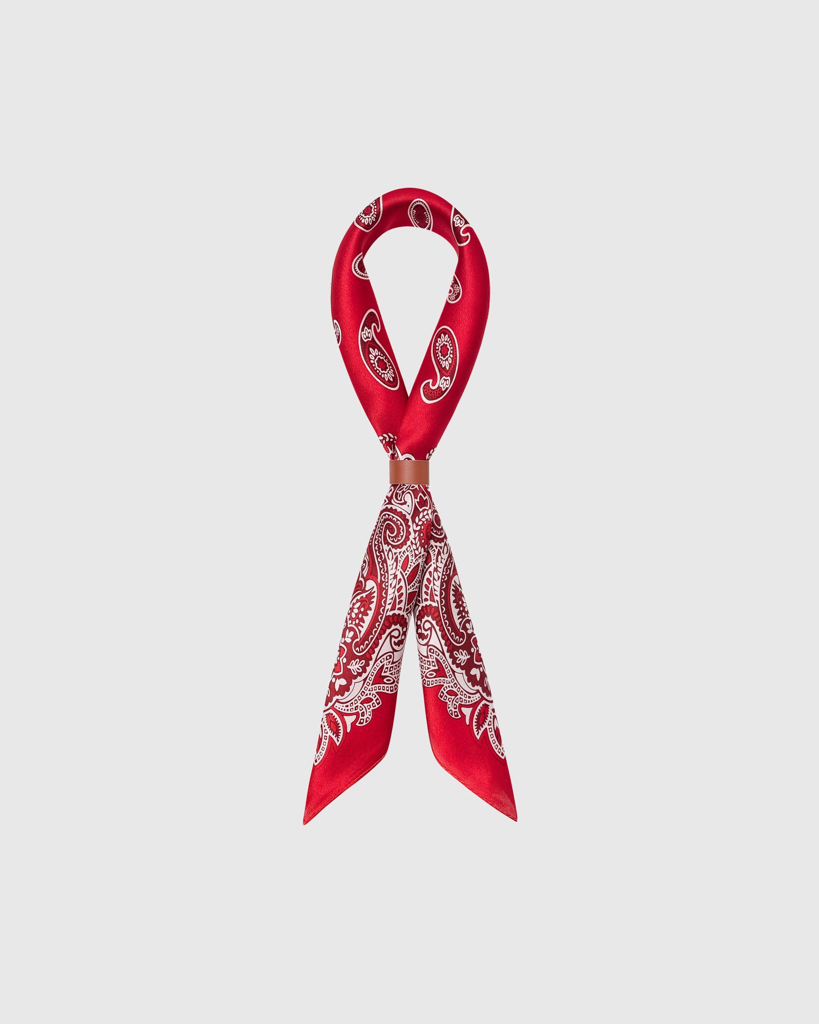 STICKYZOO crimson bandana silk scarf looped through a leather slide showing the paisley border
