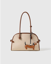 STICKYZOO leather dachshund charm clipped to a handbag, an everyday detail people notice
