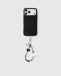 Full phone with noir heart cloud strap attached on light grey background