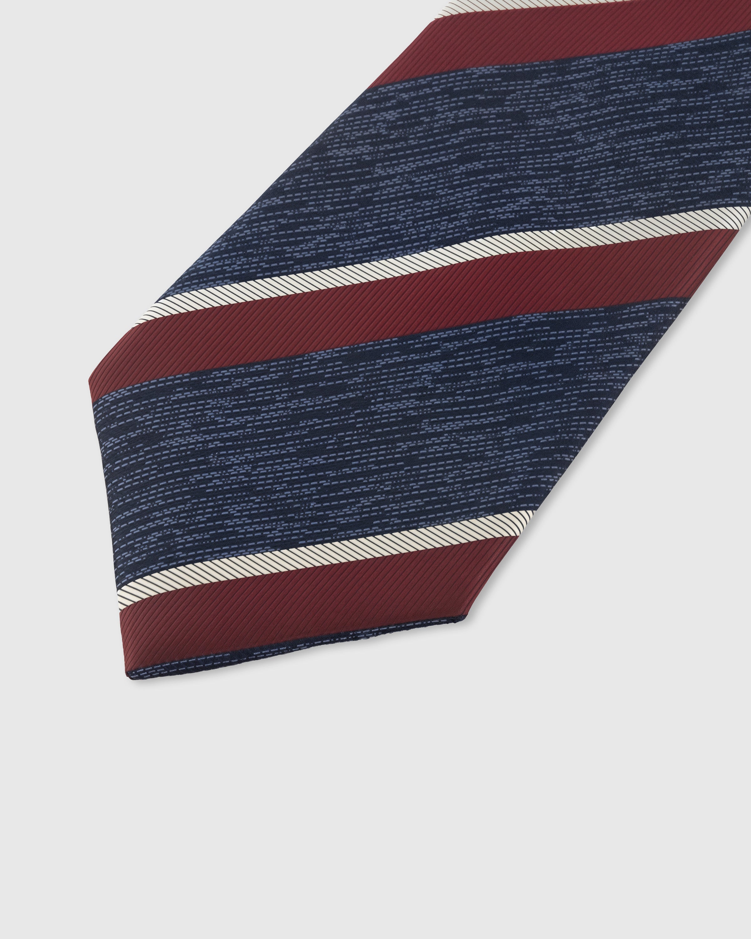 NAVY BORDEAUX STRIPE TIE — 45° Italian bias-cut construction with structured interlining, hand-finished slip stitching visible on interior