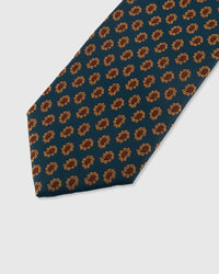 STICKYZOO TEAL FOULARD TIE — hand-embroidered detail showing amber and terracotta petal foulard motifs, stitched not printed