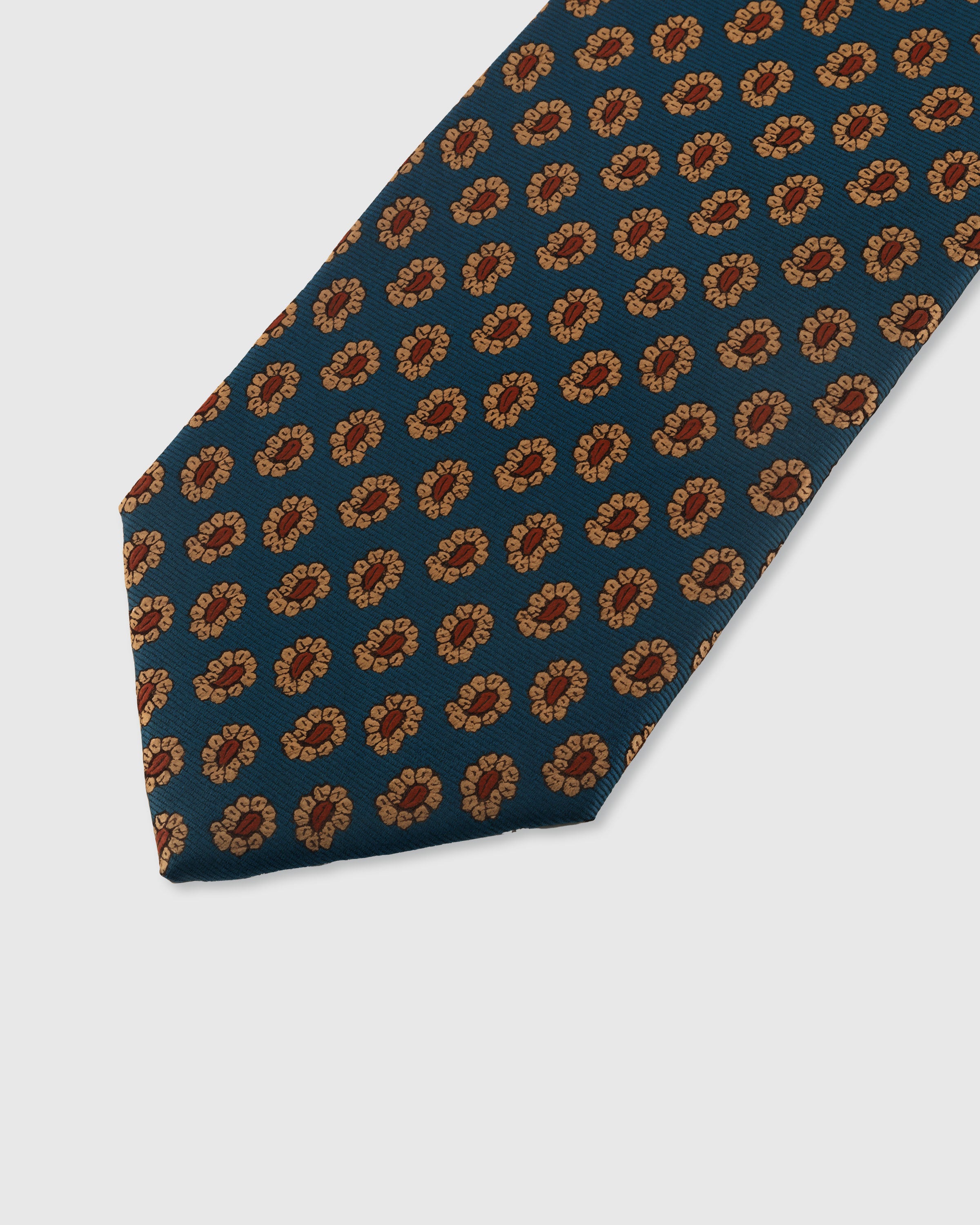 STICKYZOO TEAL FOULARD TIE — hand-embroidered detail showing amber and terracotta petal foulard motifs, stitched not printed
