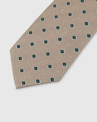 Copper paisley droplet on hunter green mulberry silk tie showing hand-embroidered layered curves by STICKYZOO