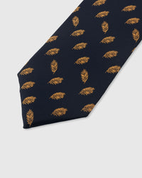 STICKYZOO NAVY FEATHER TIE — hand-embroidered detail showing golden amber floating feather motifs, stitched not printed