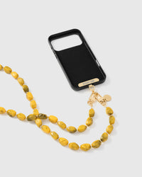 Full phone with golden smoke strap draped alongside on neutral background