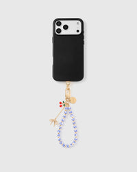 Full phone with porcelain cherry charm strap attached on light grey background