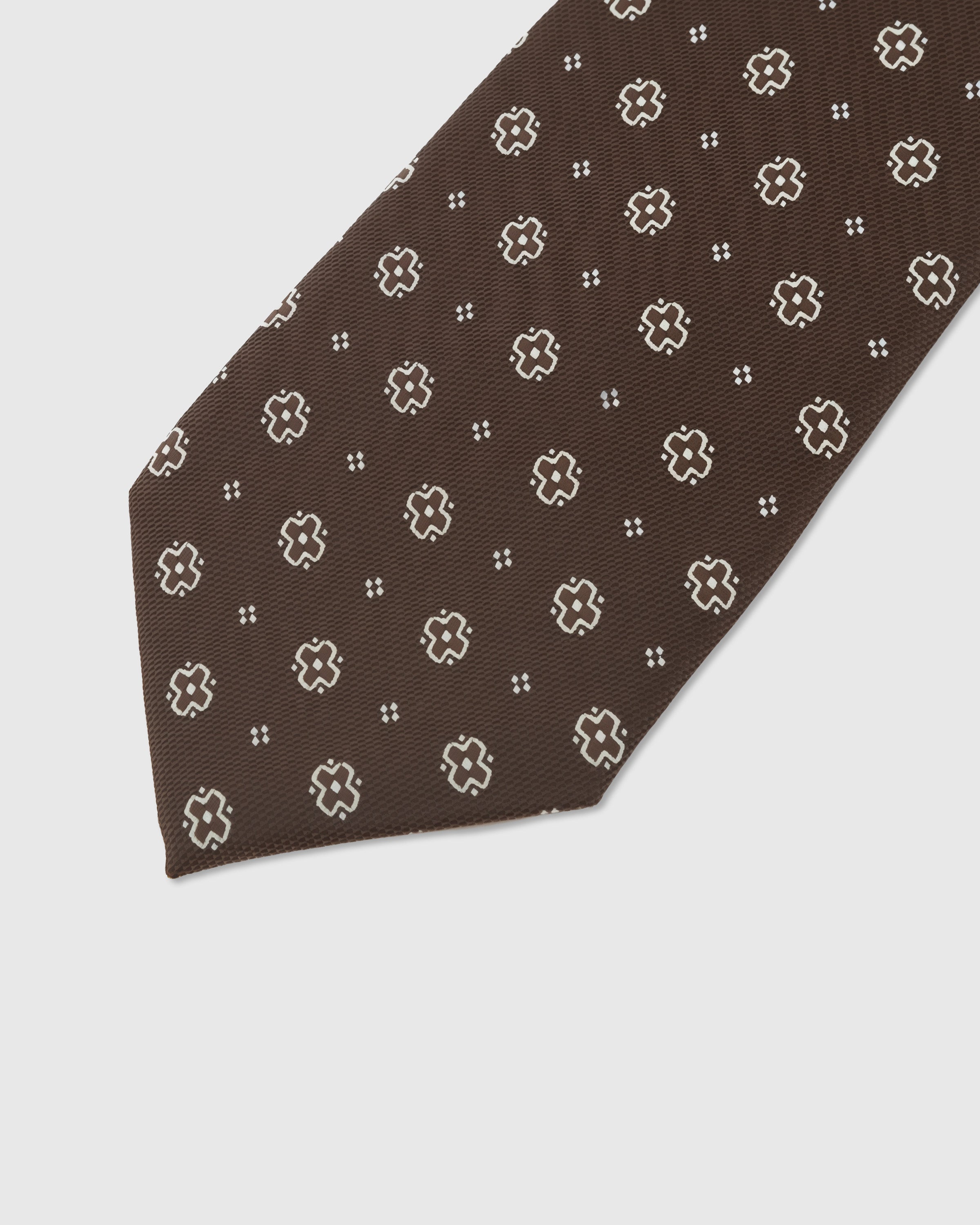 Clover dot detail on espresso mulberry silk tie showing hand-embroidered four-petal motif by STICKYZOO