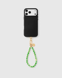 Full phone with jade speckle stone strap attached on grey background