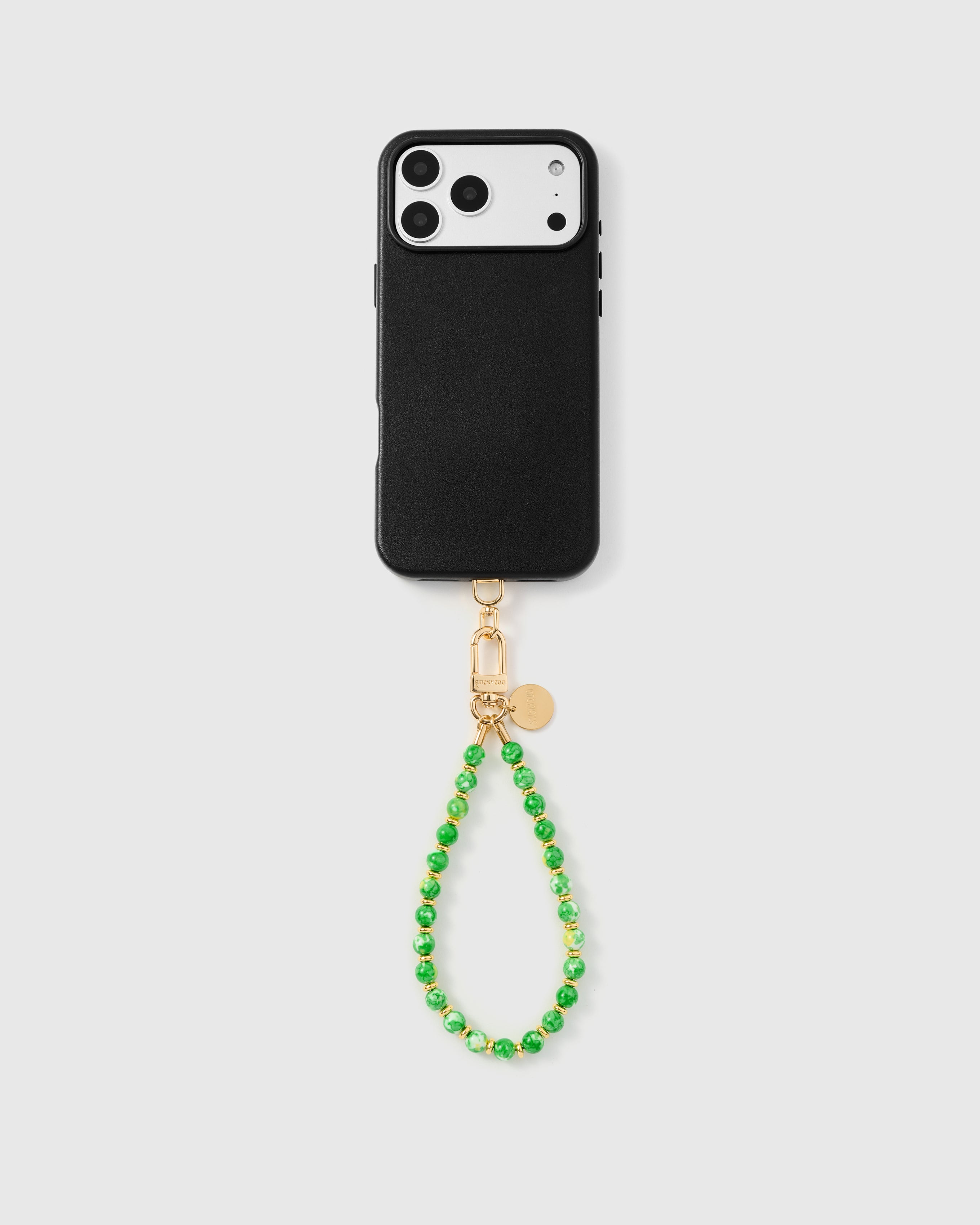 {{Works with any case}} Full phone with jade speckle stone strap attached on grey background