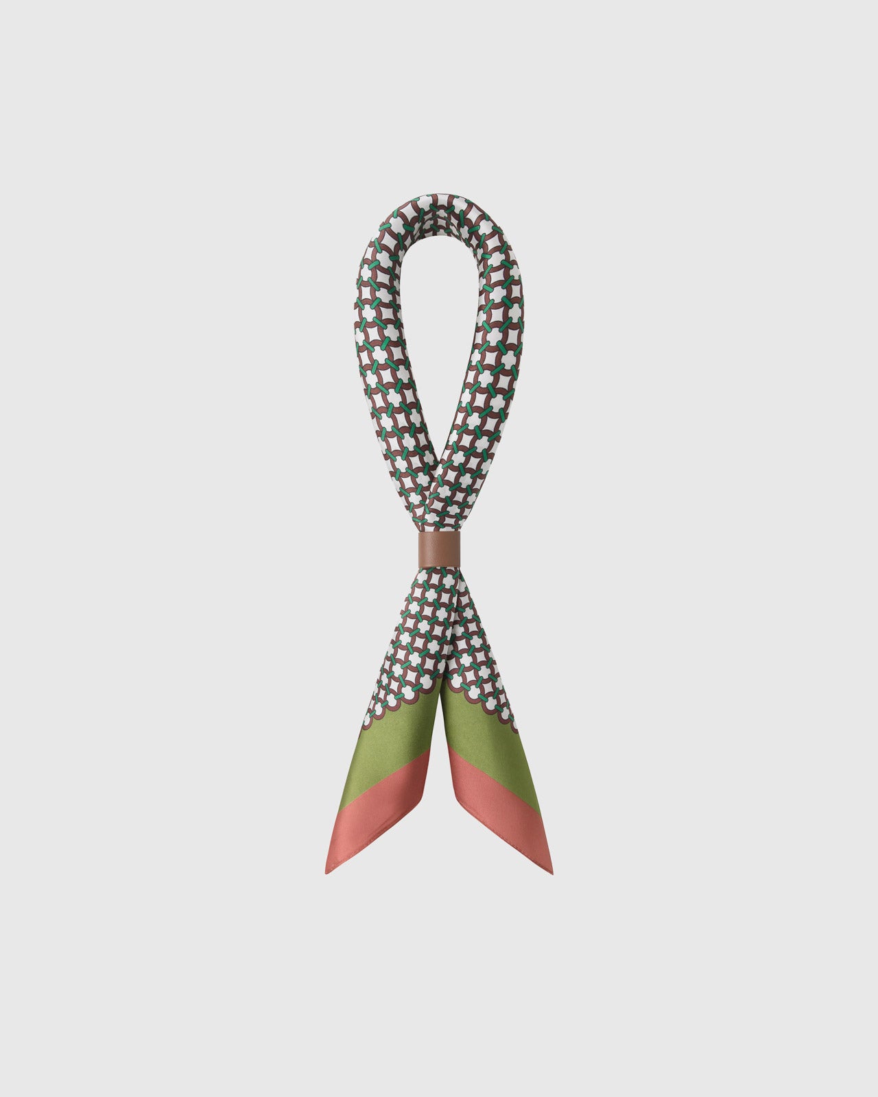STICKYZOO tile mosaic silk scarf twisted through a leather ring showing the lattice print and rose-coral edge
